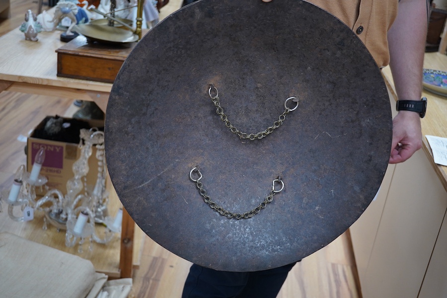 An early 20th century Persian steel shield dhal, 47cm diameter, with pairs of seated figures, brass reinforced brim, four central bosses, and silver and brass Damascene decoration, and four Burmese pottery vessels and a